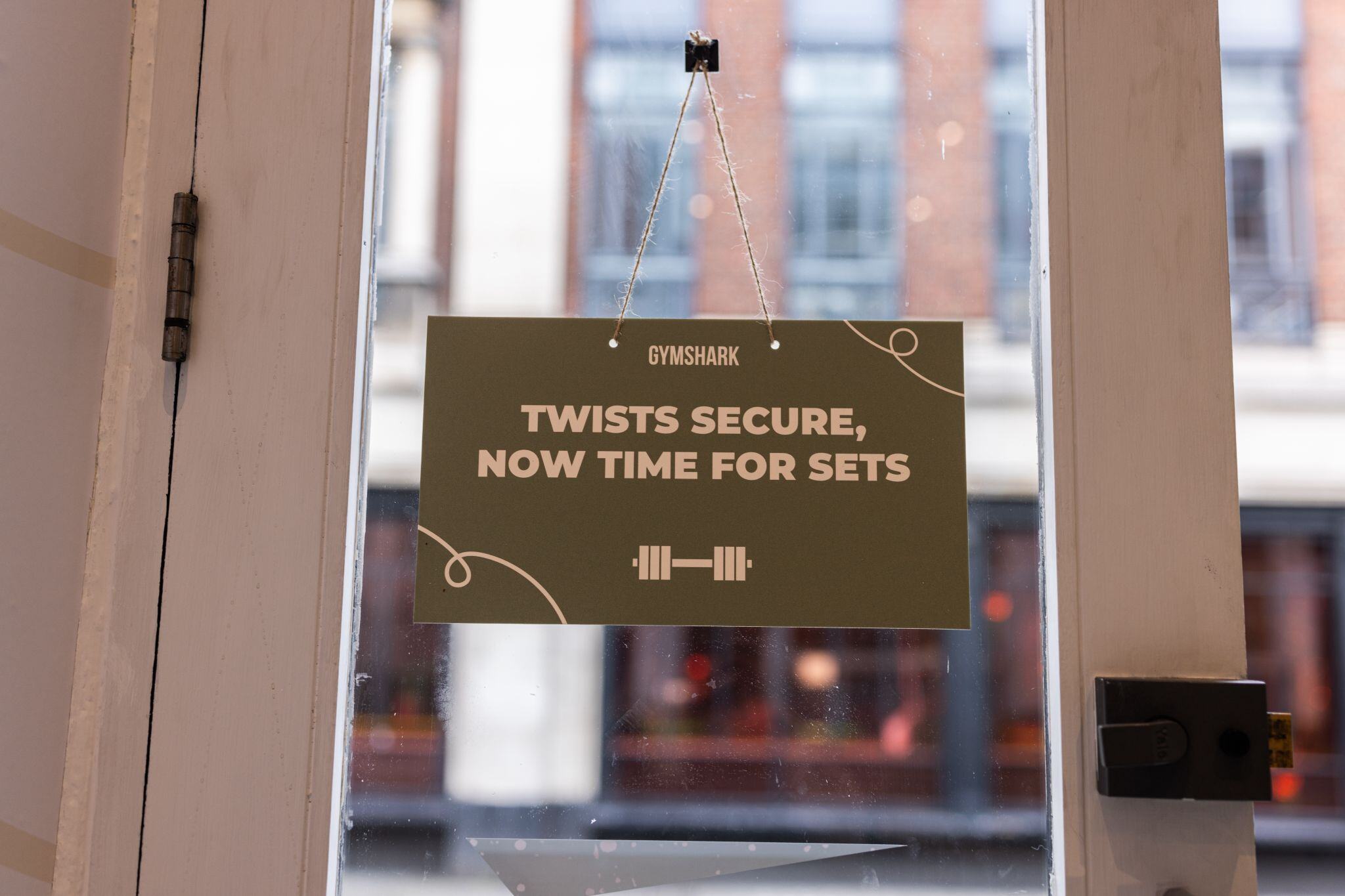 Sign on shop door reading: 'Twists secure, now time for sets'