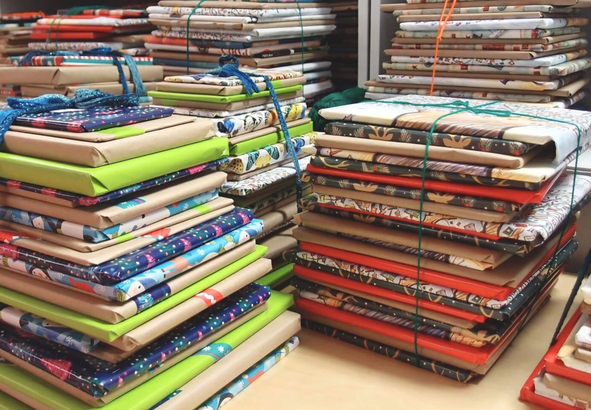 Stacks of individually wrapped books, tied with a string 