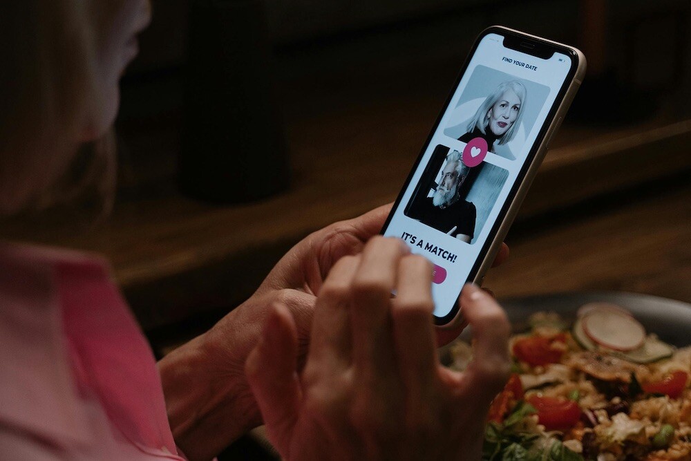 Person looking at phone showing a 'love match' 