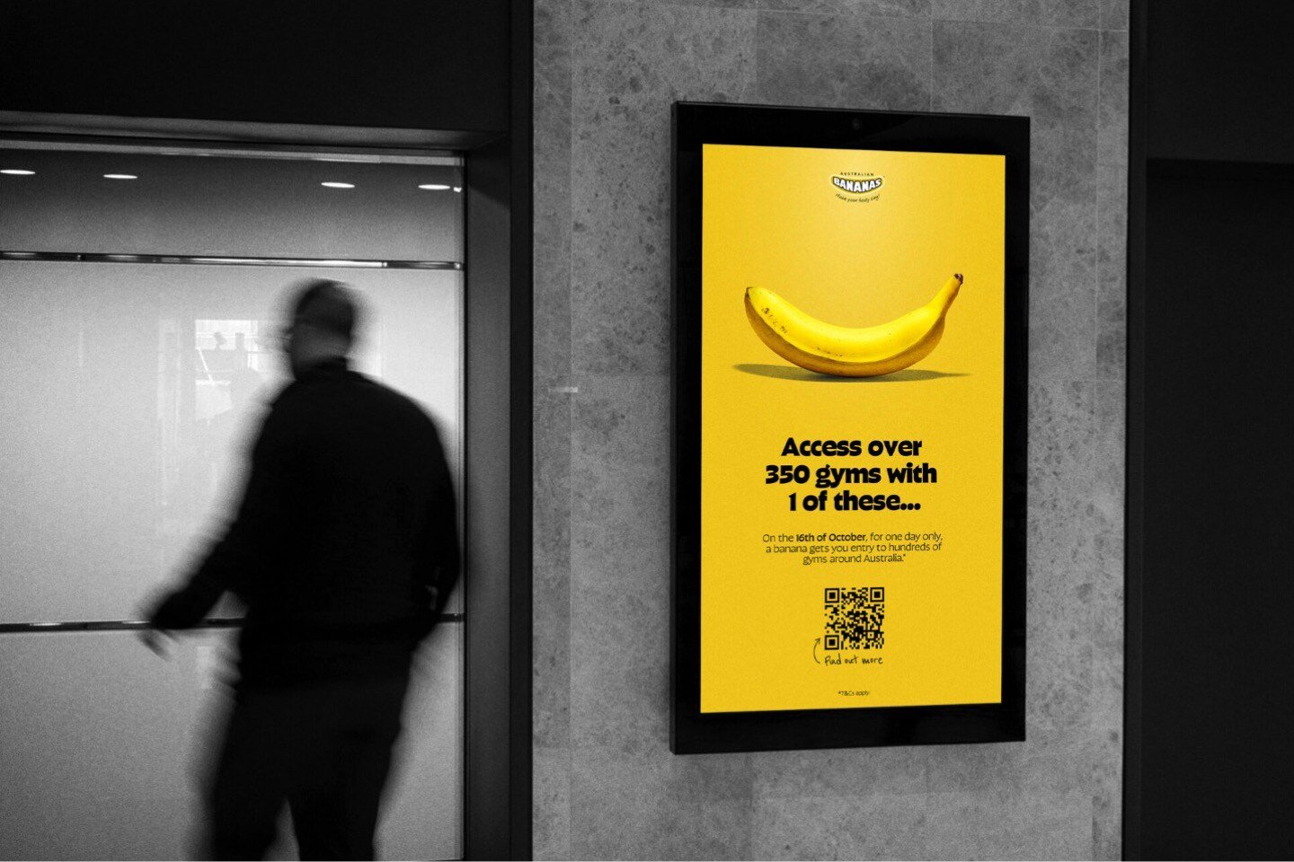 Yellow poster promoting the Banana Gym Pass, with a movement-blurred person in the background 