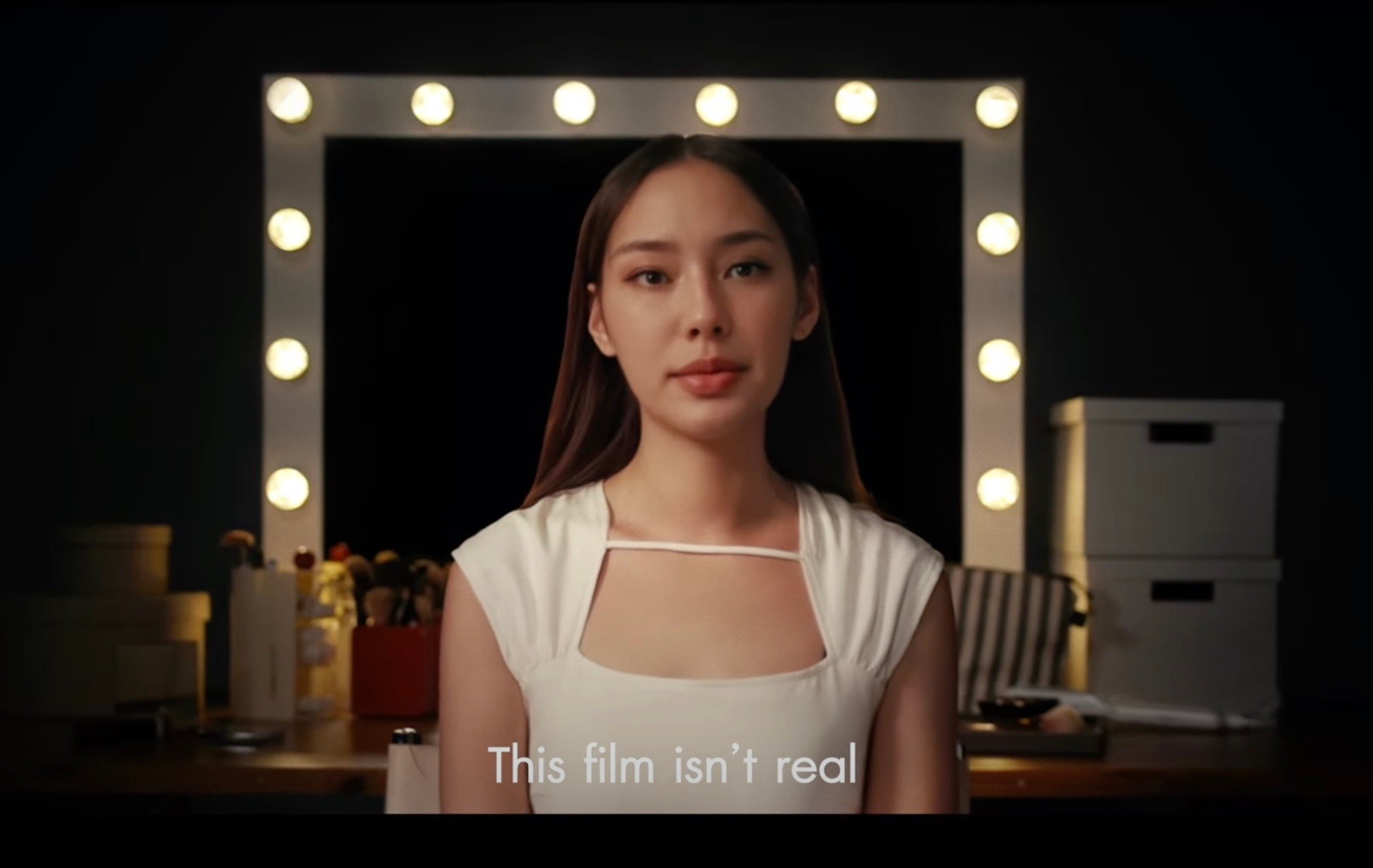 An AI-generated likeness of the late Gigi Supitcha, with the text ‘This film isn’t real’ 