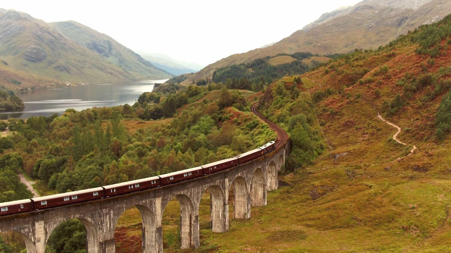 A train on elevated tracks through the Scottish Highlands 