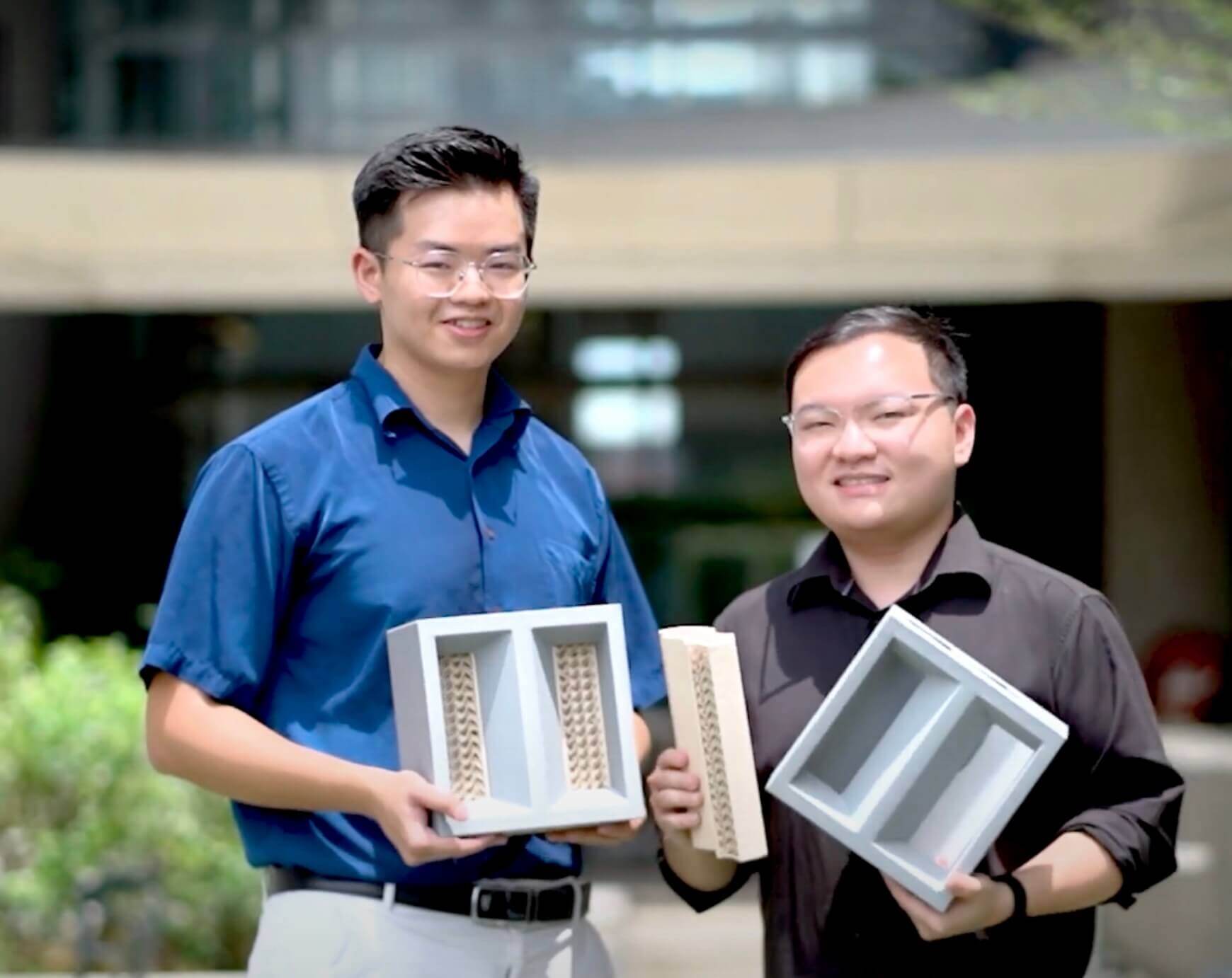 Brikoole's inventors, Chong Chee Kin and Ng Kah Zun, holding prototypes of their cooling bricks 