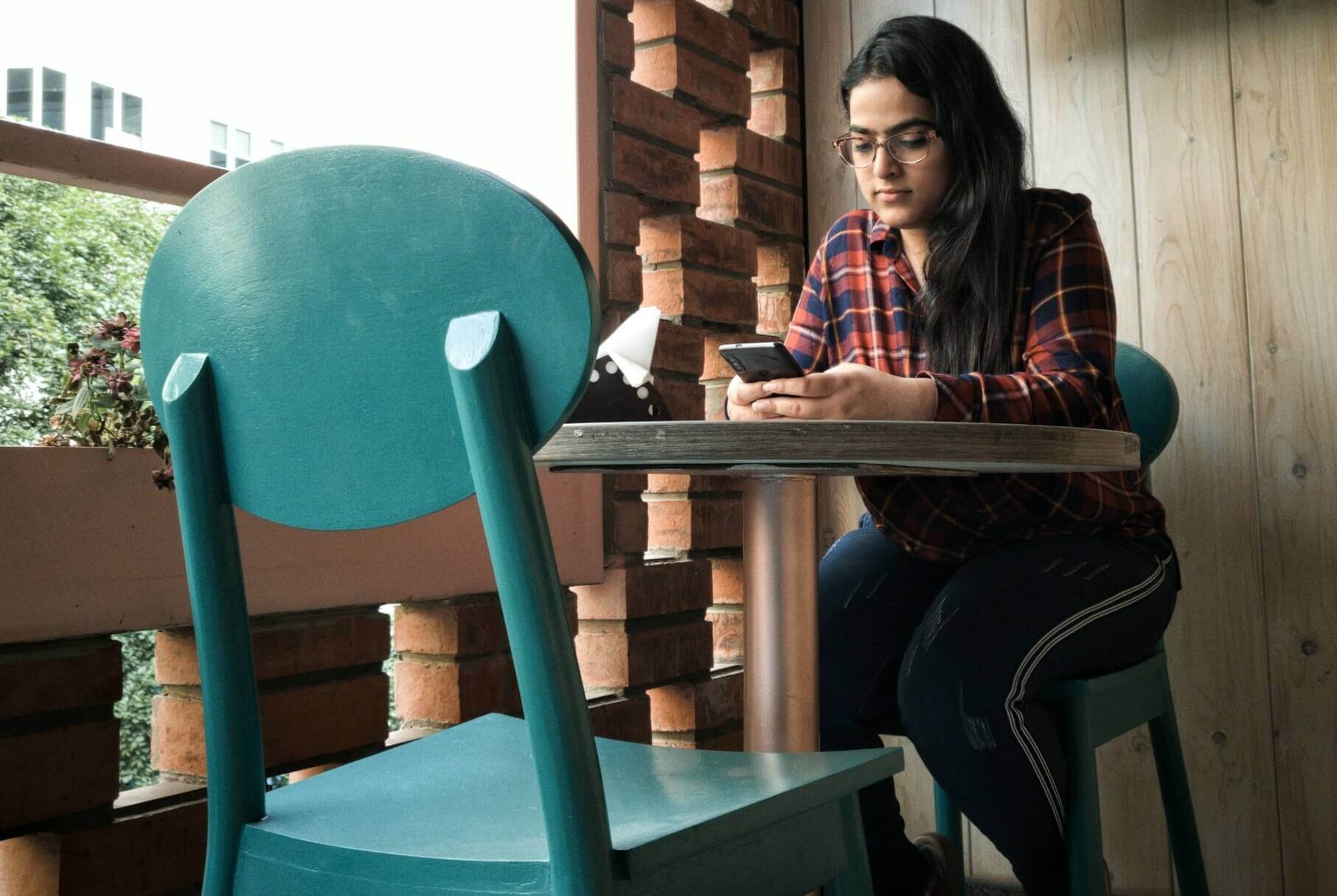 Woman in cafe looking at her phone 