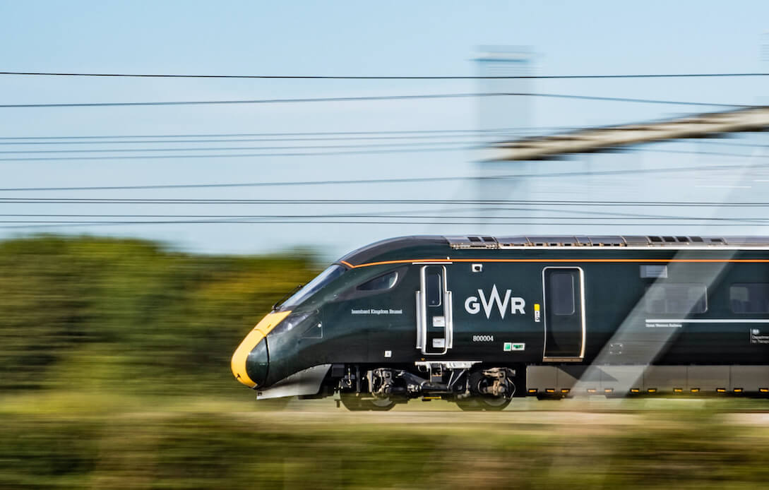 A GWR train speeding through a blurred landscape 