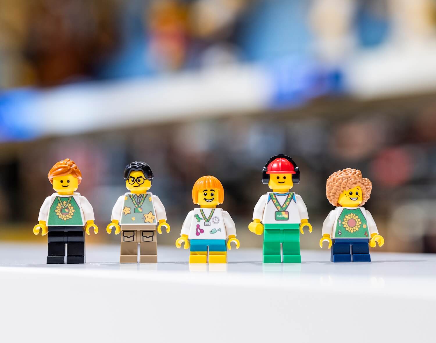 Five LEGO minifigures wearing Sunflower lanyards and/or shirts 