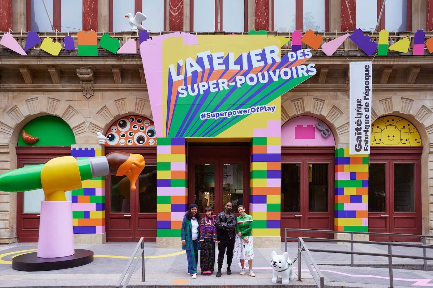 Curator and artists in front of LEGO's Atelier des Super-Pouvoirs 