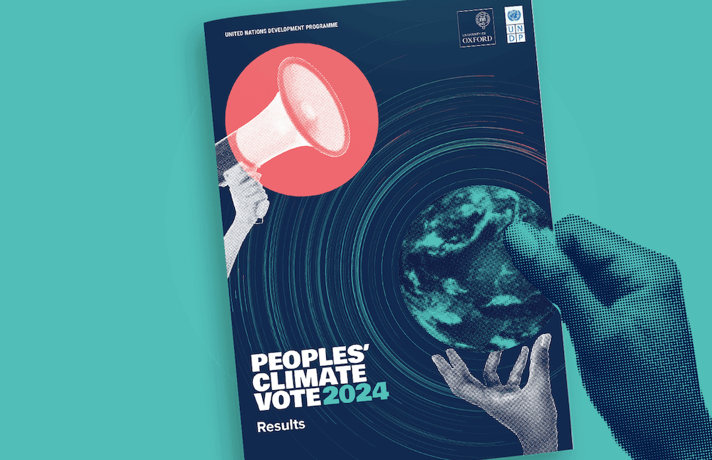 A hand holding a copy of the Peoples’ Climate Vote 2024 