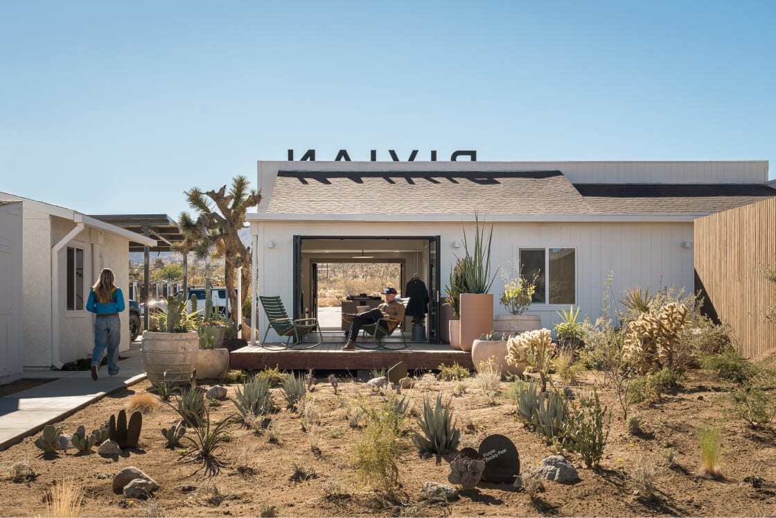 People relaxing outside Rivian's Joshua Tree charging station 