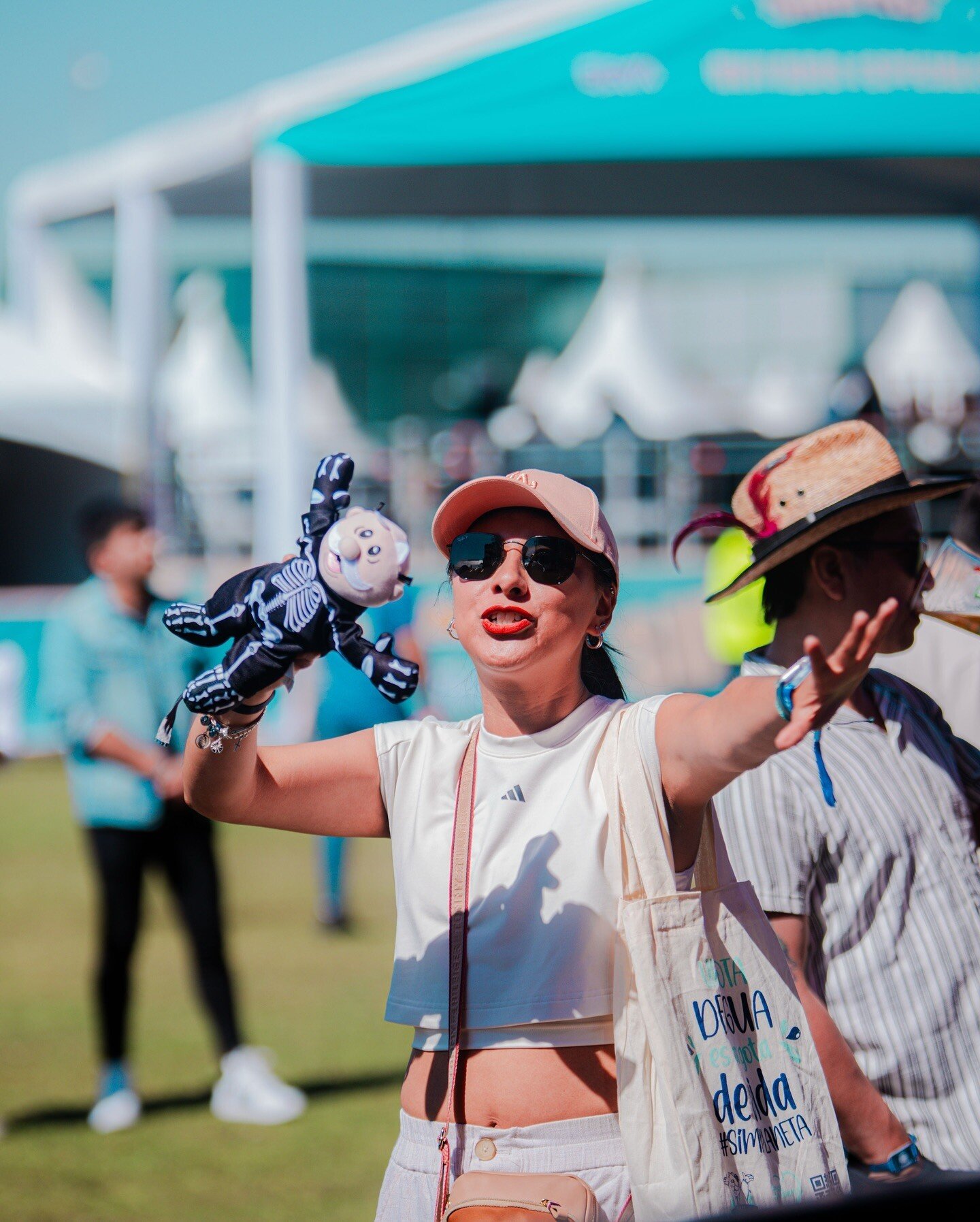 A Simifest attendee dancing while holding a Dr. Simi doll 