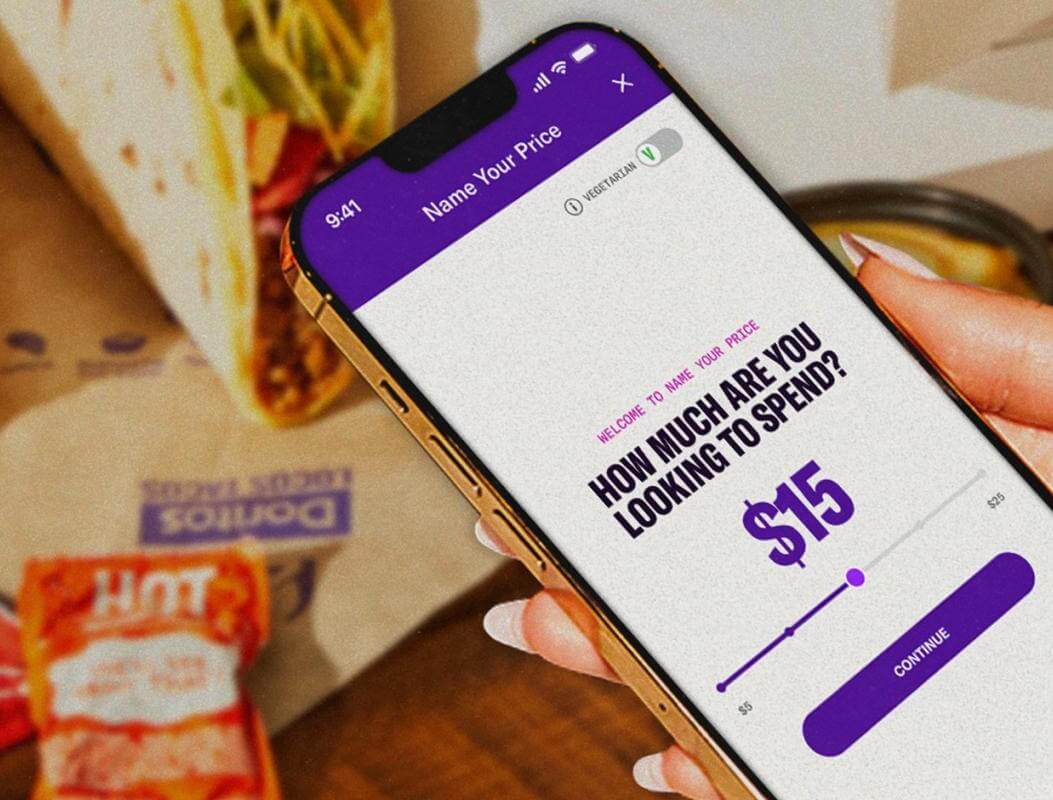 Taco Bell's app on a phone, asking the user 'How much are you looking to spend?', with a taco in the background 