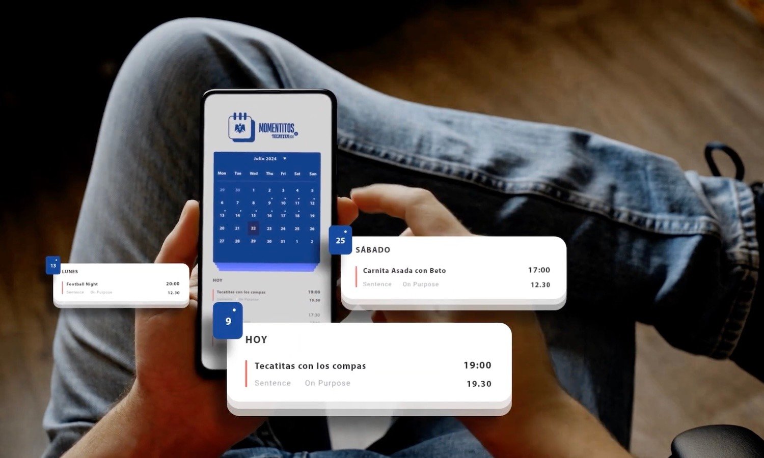 From the point of view of a seated user, a phone showing Tecate's scheduling app 