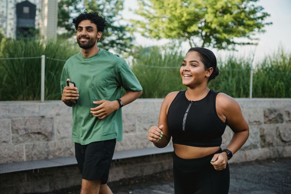 Two people running and looking happy 