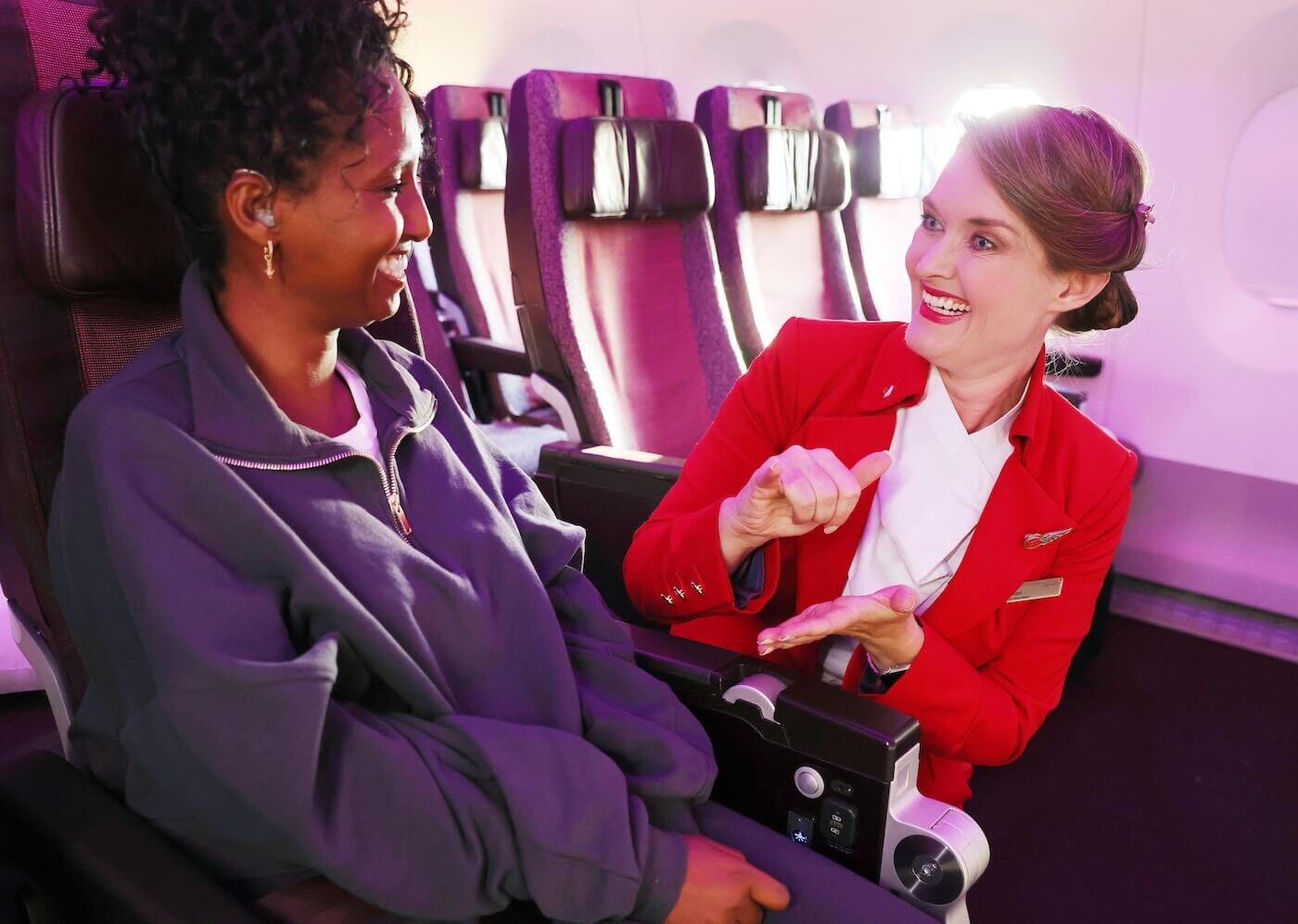 Virgin Atlantic flight attendant chatting with a passenger in BSL 